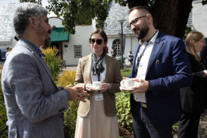 Two men and a woman having a conversation in the courtyard
