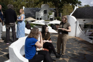 3 women having a conversation with snacks at a conference